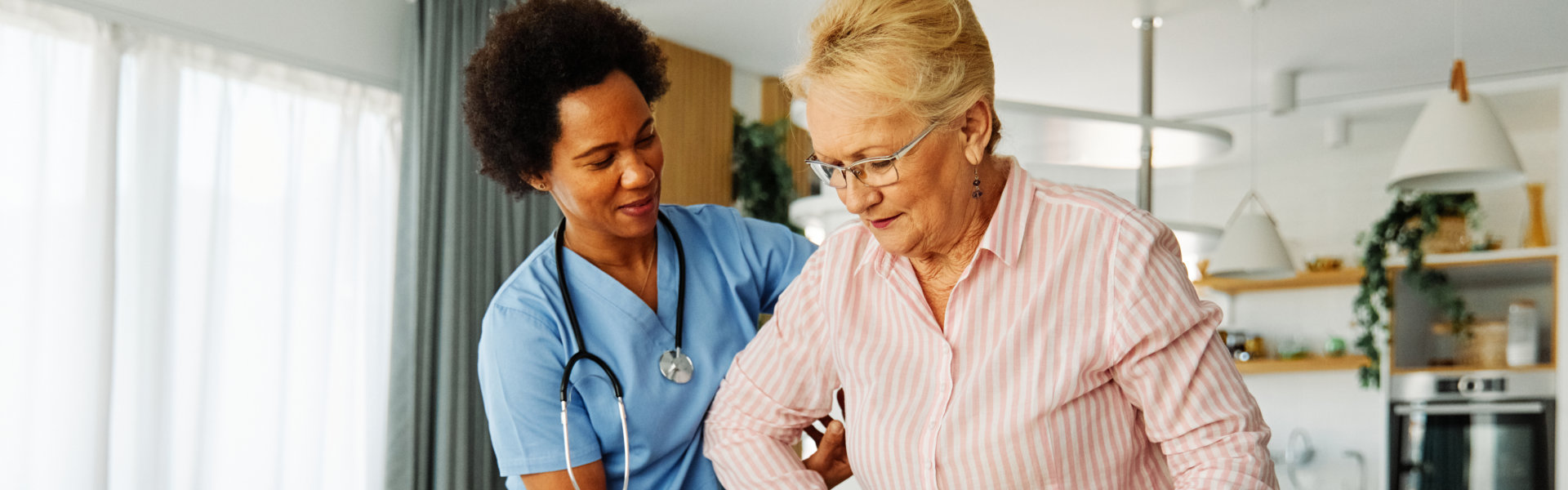 nurse assisting an elderly